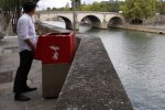 One urinal, placed near Notre Dame cathedral, overlooks passing tourist boats..jpg